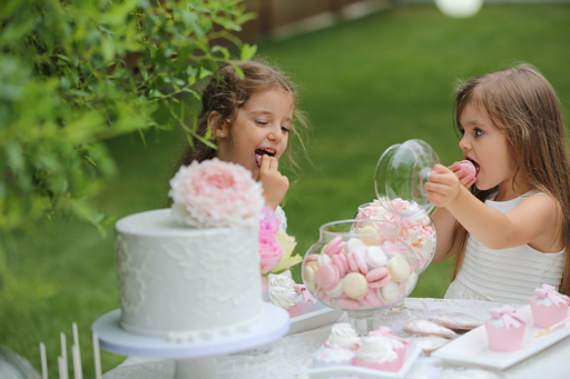 Two little girls eating cake